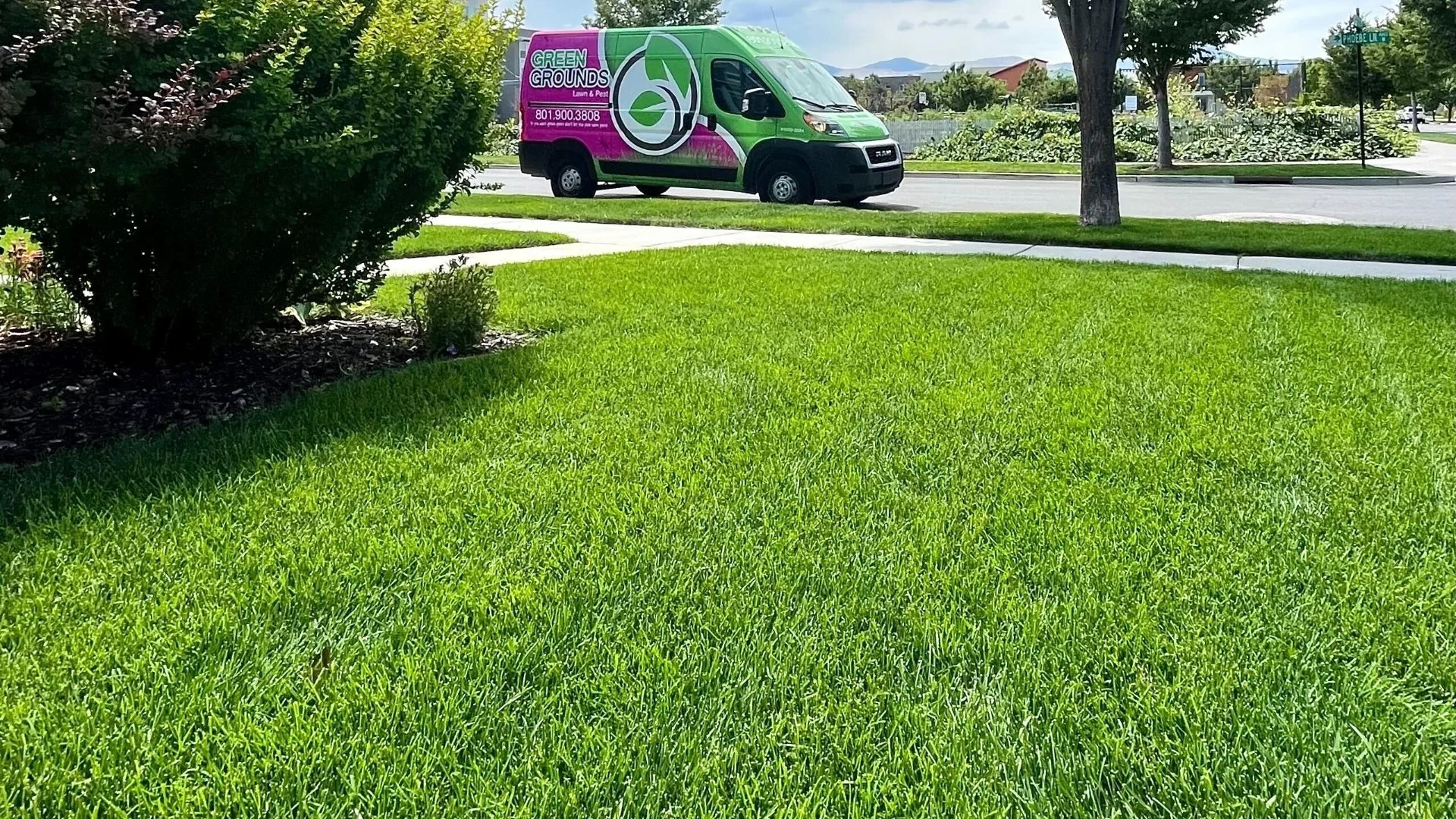 Green Grounds Lawn & Pest truck in front of customer's lawn in Salt Lake City, UT.
