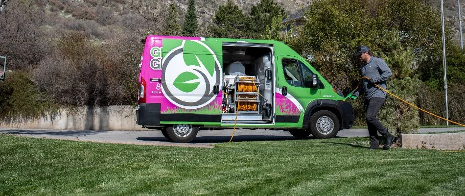 Green Grounds Lawn & Pest worker in Midway, UT, treating a lawn.