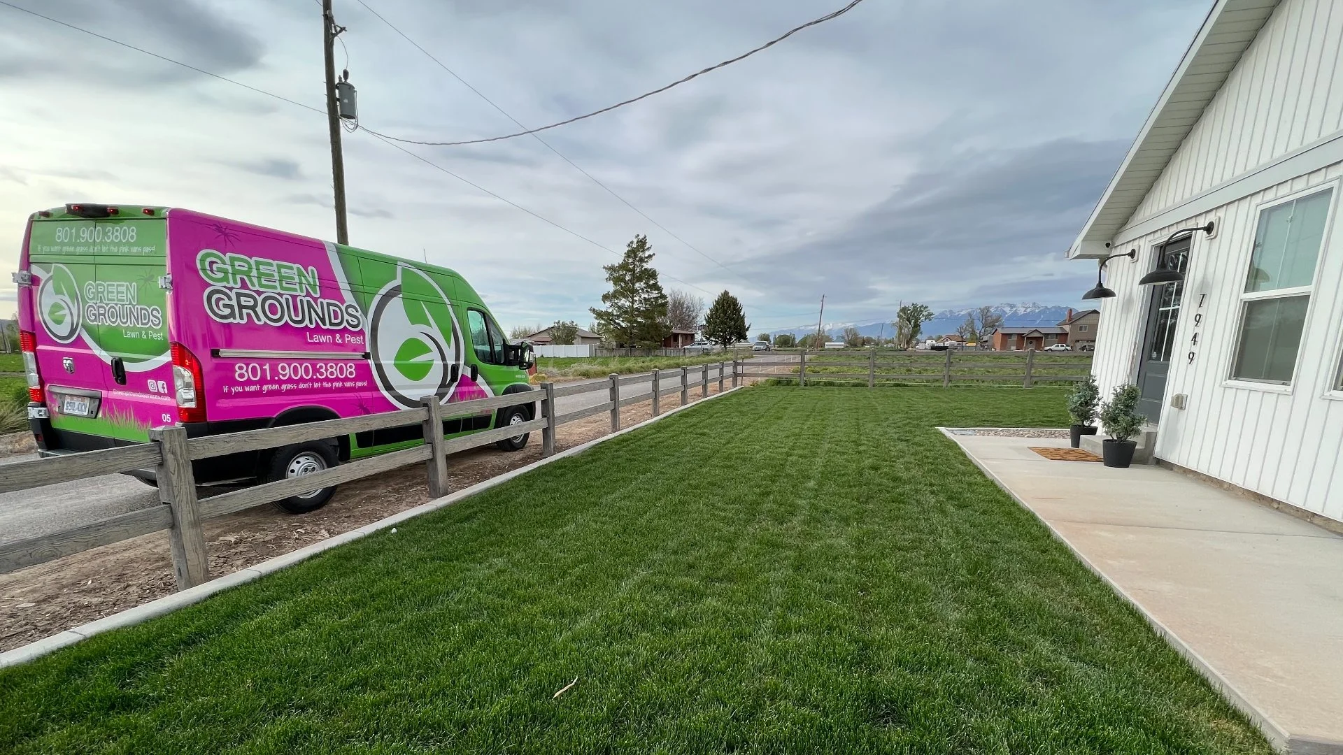 Green Grounds Lawn & Pest van at customer's house in Midway, UT for weed control treatments.