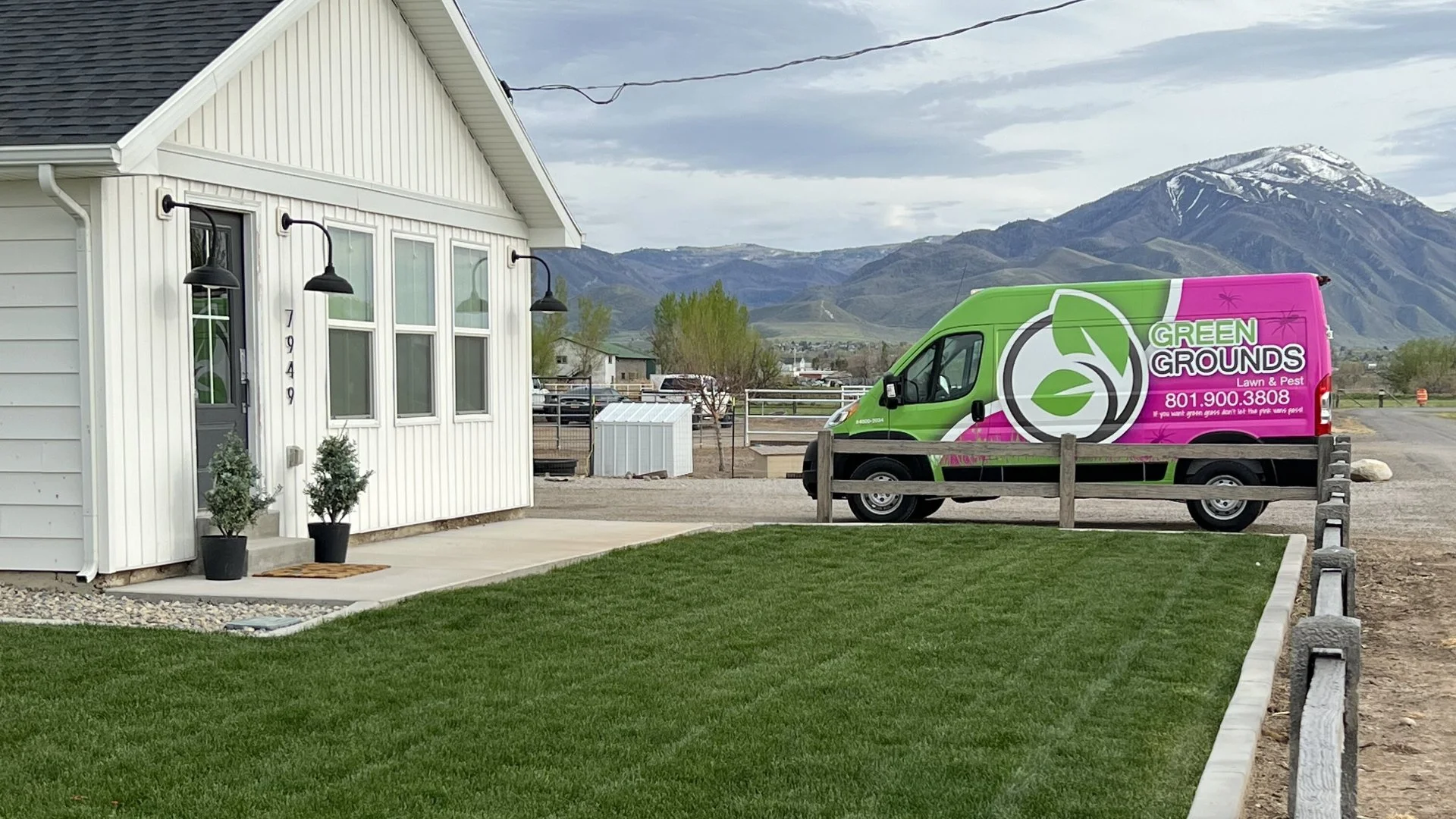 Green Grounds Lawn & Pest van arriving to apply lawn fertilizer treatments on a property in Midway, UT.
